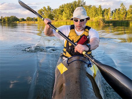 simsearch:400-07795226,k - senior male paddler training in a fast sea kayak used in adventure racing - bow view with a motion blur Foto de stock - Royalty-Free Super Valor e Assinatura, Número: 400-07791816