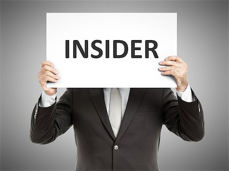 A business man holding a paper in front of his face with the text insider Stock Photo - Budget Royalty-Free & Subscription, Code: 400-07792804