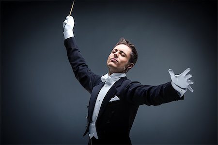 Emotional conductor in a tuxedo on a dark background Foto de stock - Royalty-Free Super Valor e Assinatura, Número: 400-07792852