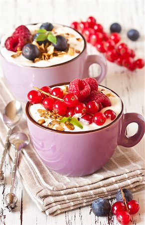 simsearch:400-06761866,k - Yogurt with granola and fresh berries on an old wooden board. Photographie de stock - Aubaine LD & Abonnement, Code: 400-07792938