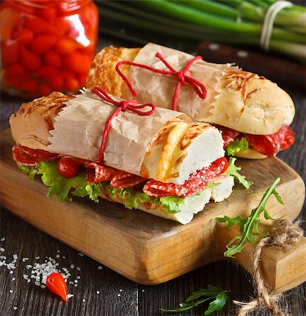 simsearch:400-07792940,k - Salami sandwiches with lettuce and sweety drop peppers on an old wooden board. Stock Photo - Budget Royalty-Free & Subscription, Code: 400-07792940