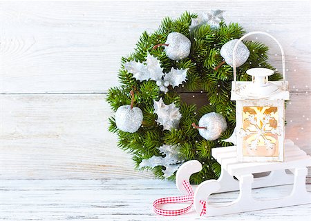 Christmas wreath and candle lantern with sledge lon an old wooden background with copy space. Photographie de stock - Aubaine LD & Abonnement, Code: 400-07792992