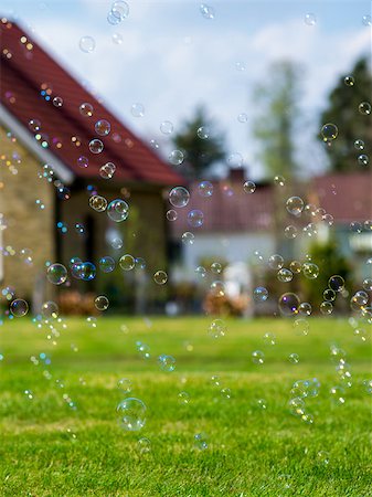 dfaagaard (artist) - Soap bubbles drifting across a green lawn with suburban houses in the background. Stock Photo - Budget Royalty-Free & Subscription, Code: 400-07793069