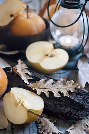 simsearch:400-07932348,k - Ripe asian pears, lantern with candle and fall leaves on wooden table. Autumn concept. Selective focus. Foto de stock - Super Valor sin royalties y Suscripción, Código: 400-07793405