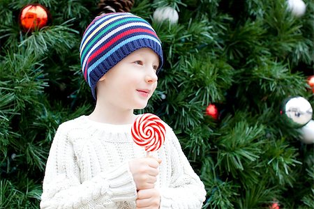 silly winter boy - cute little boy with candy cane at christmas time Stock Photo - Budget Royalty-Free & Subscription, Code: 400-07793415