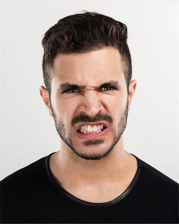 face man latino isolated - Studio portrait of a handsome young man astonished with a angry expression Stock Photo - Budget Royalty-Free & Subscription, Code: 400-07793639