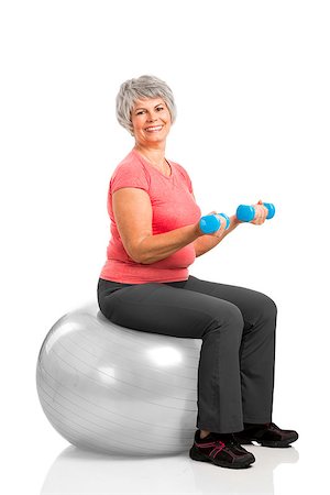 Happy fitness old woman lifting dumbbells while sitting over a PIlates ball Stock Photo - Budget Royalty-Free & Subscription, Code: 400-07793661