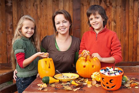 simsearch:400-07793720,k - Happy woman and kids preparing for Halloween - carving pumpkin jack-o-lanterns Photographie de stock - Aubaine LD & Abonnement, Code: 400-07793713