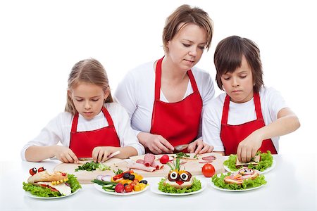 family eating burgers - Kids and their mother preapring the party sandwiches - funny food creatures, isolated Stock Photo - Budget Royalty-Free & Subscription, Code: 400-07793727