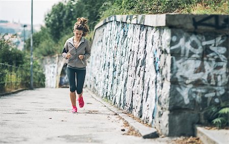 simsearch:400-07682342,k - Fitness young woman jogging in the city park. rear view Stock Photo - Budget Royalty-Free & Subscription, Code: 400-07793981