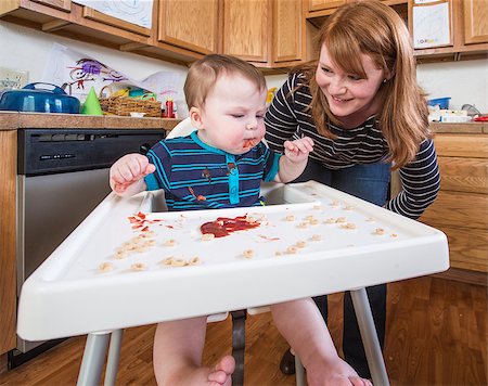 A woman feeds her baby breakfast in the kitchen Stock Photo - Budget Royalty-Free & Subscription, Code: 400-07816957