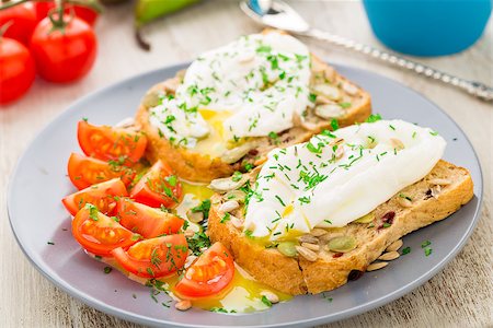 eat boiled egg - Breakfast sandwich with poached egg and cherry tomatoes. Stock Photo - Budget Royalty-Free & Subscription, Code: 400-07817017