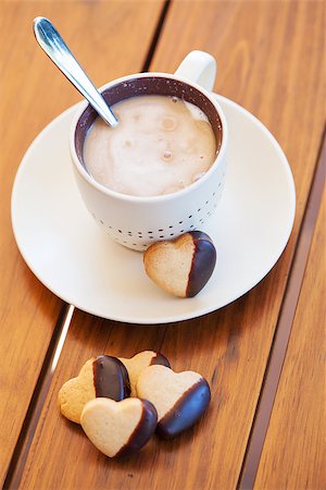 Cup of coffee served with chocolate-dipped heart shaped biscuits Stock Photo - Budget Royalty-Free & Subscription, Code: 400-07817329