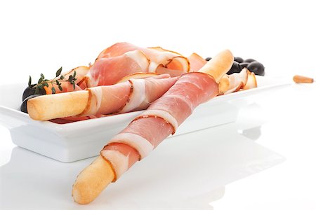 simsearch:400-08070576,k - Gourmet food. Delicious prosciutto ham background with black olives, fresh herbs and grissini breadsticks. Foto de stock - Super Valor sin royalties y Suscripción, Código: 400-07817726