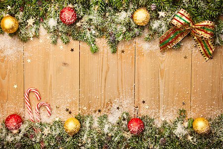Christmas background with firtree, candies and baubles with snow and stars on wood Stock Photo - Budget Royalty-Free & Subscription, Code: 400-07817732