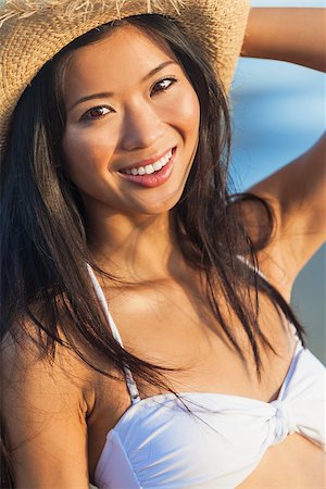 simsearch:400-06421494,k - Beautiful smiling happy young Asian Chinese woman or girl in white bikini and cowboy hat on a tropical beach Foto de stock - Super Valor sin royalties y Suscripción, Código: 400-07817853