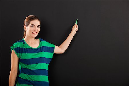Happy woman writing on  chalkboard, with copy space for designer Stock Photo - Budget Royalty-Free & Subscription, Code: 400-07817876