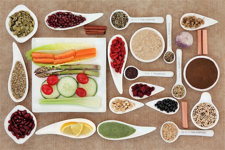 simsearch:400-08429907,k - Large weight loss and health super food selection in porcelain bowls and measuring spoons over brown paper background. Fotografie stock - Microstock e Abbonamento, Codice: 400-07818343