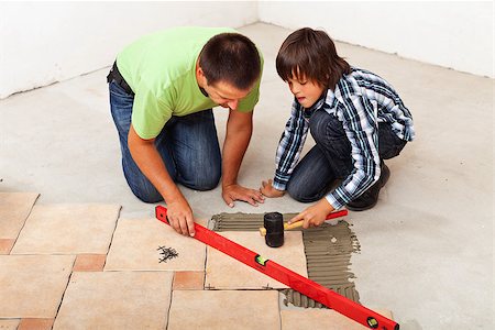 Man and boy laying ceramic floor tiles together Photographie de stock - Aubaine LD & Abonnement, Code: 400-07819149