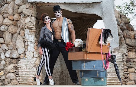 Muscular cirque performer with bizarre female partner in striped pants Fotografie stock - Microstock e Abbonamento, Codice: 400-07819365