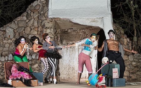 Group of silly cirque clowns playing tug-of-war Fotografie stock - Microstock e Abbonamento, Codice: 400-07819380