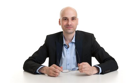 simsearch:400-07820348,k - portrait of a cheerful businessman sitting at a table, isolated over white background Photographie de stock - Aubaine LD & Abonnement, Code: 400-07824655