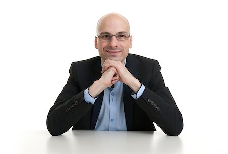 simsearch:400-07820348,k - portrait of a cheerful businessman sitting at a table, isolated over white background Photographie de stock - Aubaine LD & Abonnement, Code: 400-07824652