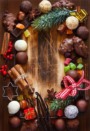 simsearch:400-07824858,k - Christmas sweets frame card. Chocolate truffles, candied fruit, nuts and christmas spices on a wooden background with place for text. Stock Photo - Budget Royalty-Free & Subscription, Code: 400-07824848