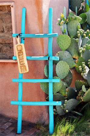 Colorful turquoise, wooden ladder catches the eye of visitors to "old town", Albuquerque, New Mexico.  Sign attached says "open" and cactus is blooming on corner. Stock Photo - Budget Royalty-Free & Subscription, Code: 400-07825281