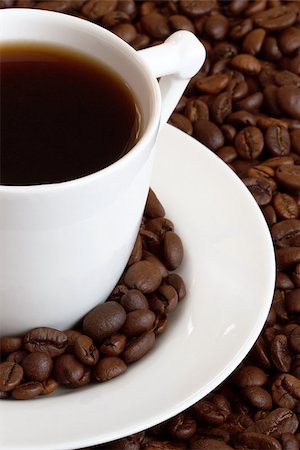 a cup of coffe and coffe-beans around it Stockbilder - Microstock & Abonnement, Bildnummer: 400-07825345