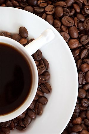 top view of a cup of coffe and coffe-beans around it Stockbilder - Microstock & Abonnement, Bildnummer: 400-07825346