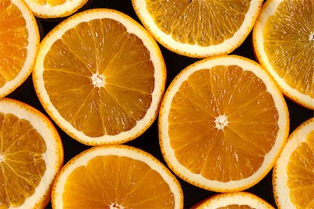 slices of oranges on the black background Stockbilder - Microstock & Abonnement, Bildnummer: 400-07825352