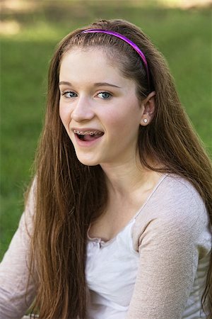 smile teeth braces - Single laughing teenage female with braces on teeth Stock Photo - Budget Royalty-Free & Subscription, Code: 400-07825503