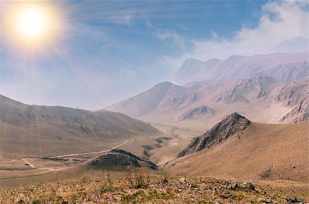 Mountain landscape with road under sun Stockbilder - Microstock & Abonnement, Bildnummer: 400-07825625