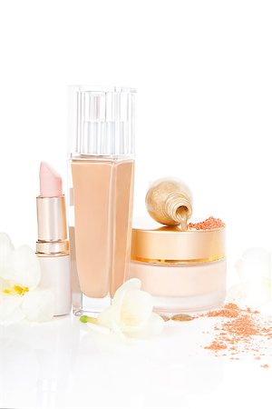 simsearch:400-09142582,k - Glamour beige Make up and Cosmetics still life. Beige foundation, moisturizer, ground facial powder and golden nail polish with yellow flower and petal isolated on white background. Foto de stock - Super Valor sin royalties y Suscripción, Código: 400-07825776