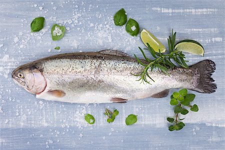 simsearch:400-07776969,k - Fresh trout with sea salt, lime, rosemary and fresh basil leaves on blue and white wooden background, top view. Luxurious mediterranean seafood background. Foto de stock - Super Valor sin royalties y Suscripción, Código: 400-07825856