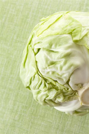 simsearch:400-07822704,k - Green cabbage isolated on green background. Culinary healthy vegetable background. Photographie de stock - Aubaine LD & Abonnement, Code: 400-07825851