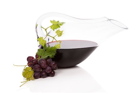 simsearch:400-07772886,k - Red vine in luxurious carafe with red grapes, vine leaves and wine corks isolated on white background with reflection. Stock Photo - Budget Royalty-Free & Subscription, Code: 400-07825870