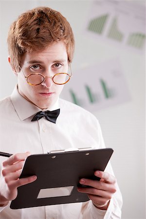 a redheaded clerk with glasses looking at you with suspicion Stock Photo - Budget Royalty-Free & Subscription, Code: 400-07826683