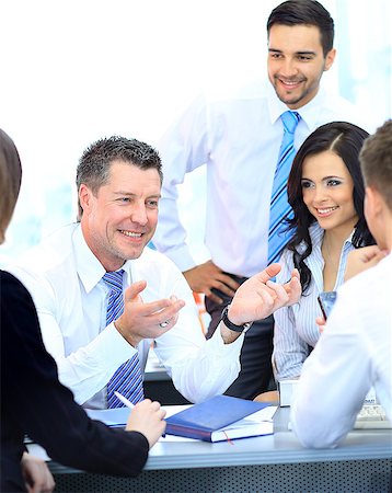 Business people working and discussing together at meeting in office Stock Photo - Budget Royalty-Free & Subscription, Code: 400-07826933