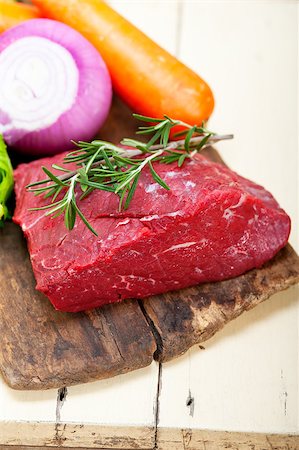 fresh raw beef cut ready to cook with vegetables and herbs Stock Photo - Budget Royalty-Free & Subscription, Code: 400-07827649