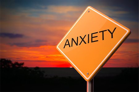simsearch:649-05521916,k - Anxiety on Warning Road Sign on Sunset Sky Background. Stock Photo - Budget Royalty-Free & Subscription, Code: 400-07827898