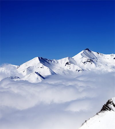 Mountains in clouds at nice day. View from ski slope. Caucasus Mountains, Georgia, Gudauri. Photographie de stock - Aubaine LD & Abonnement, Code: 400-07828122