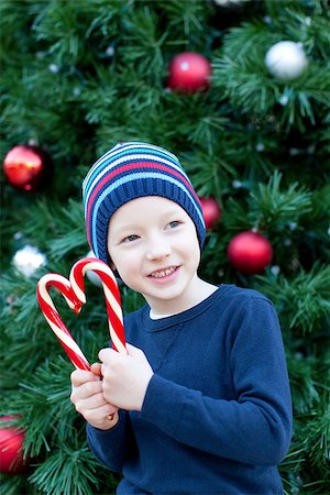 silly winter boy - funny little boy playing with candy canes at christmas time Stock Photo - Budget Royalty-Free & Subscription, Code: 400-07828228