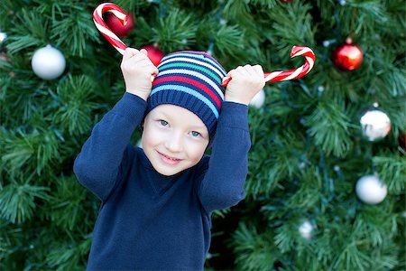 silly winter boy - funny little boy playing with candy canes at christmas time Stock Photo - Budget Royalty-Free & Subscription, Code: 400-07828237