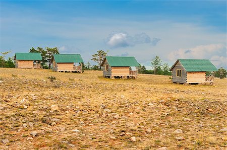 Wooden cottages  in field Stock Photo - Budget Royalty-Free & Subscription, Code: 400-07828572