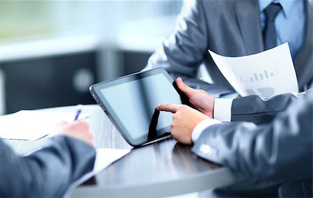 Businessman holding digital tablet at meeting Stock Photo - Budget Royalty-Free & Subscription, Code: 400-07829354