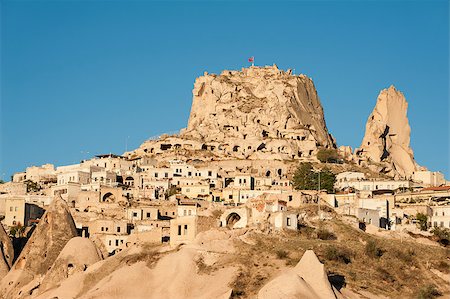 rock chimney - Ancient town and a castle of Uchisar dug from a mountains after sunrise, Cappadocia, Turkey Stock Photo - Budget Royalty-Free & Subscription, Code: 400-07829661