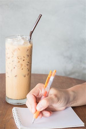 Hand writing on note paper in coffee shop, stock photo Stock Photo - Budget Royalty-Free & Subscription, Code: 400-07820944