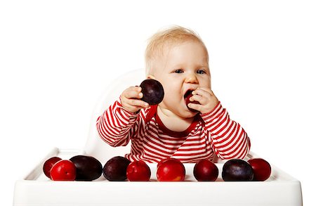 funny feeding baby - Portrait of sweet baby sitting on chair and eating plums. Stock Photo - Budget Royalty-Free & Subscription, Code: 400-07821100
